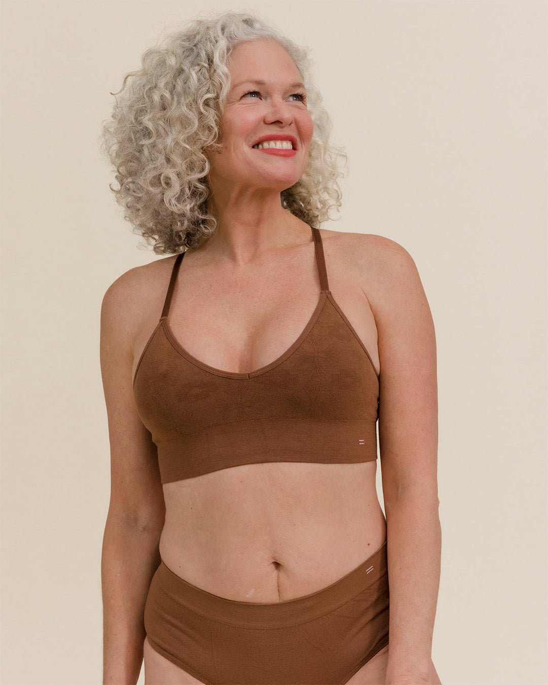 Woman wearing BRANWYN's Essential Bralette, a bra from the Essential Collection. Made from soft, moisture-wicking Merino wool using seamless technology, this performance innerwear provides performance, comfort, and sustainability. The fabric is free from BPA, PFAS, and forever chemicals.