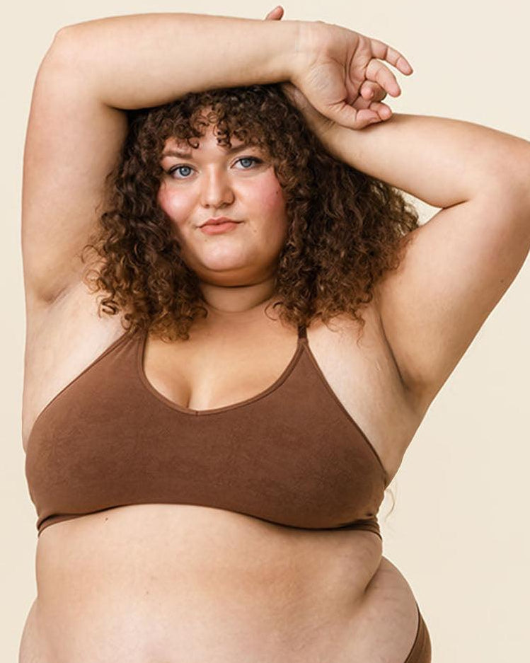 Woman in BRANWYN Essential Bralette and Merino underwear set in Dark Nude, seamless natural fiber innerwear.