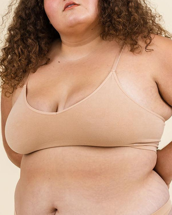 Woman wearing Merino bralette and Merino underwear set, soft seamless design for comfort.