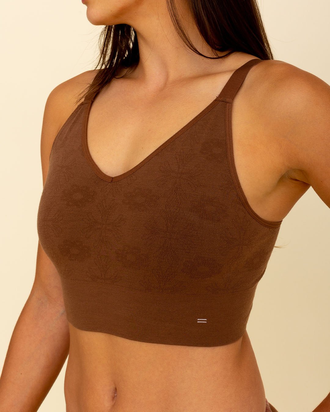 Woman wearing BRANWYN's Essential Busty Bra, a bra from the Essential Collection. Made from soft, moisture-wicking Merino wool using seamless technology, this performance innerwear provides performance, comfort, and sustainability. The fabric is free from BPA, PFAS, and forever chemicals.