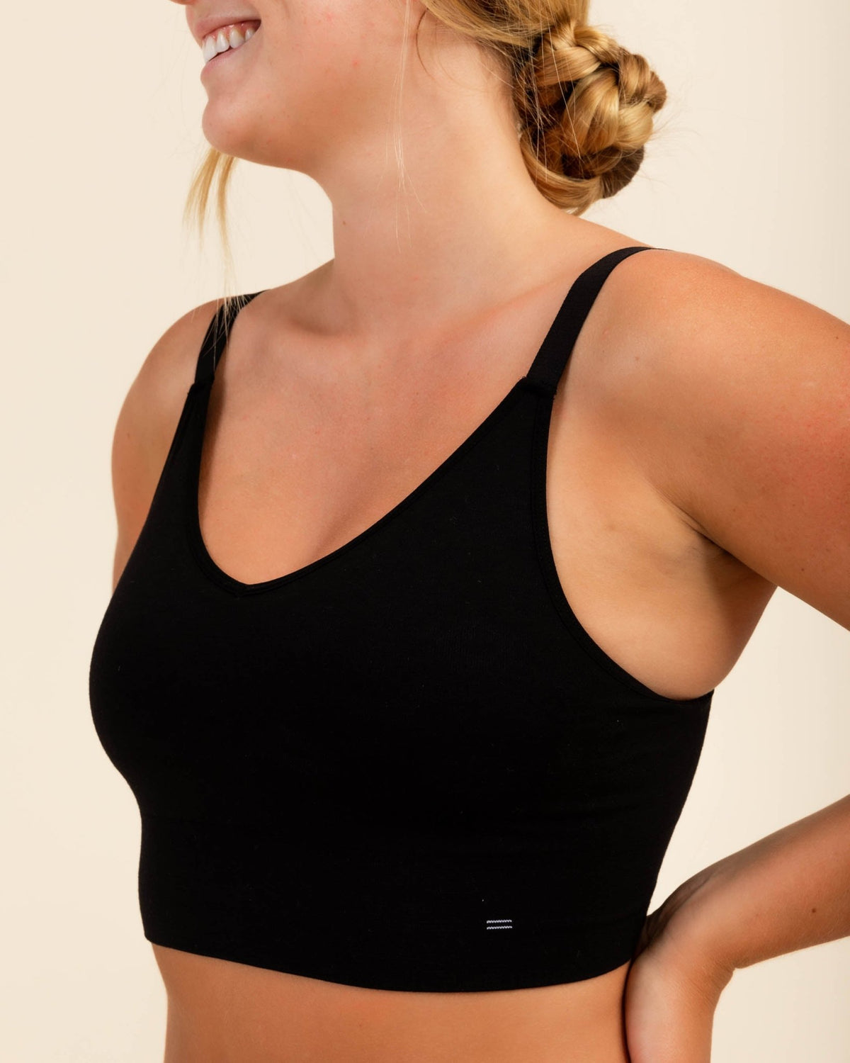 Woman wearing BRANWYN's Essential Busty Bra, a bra from the Essential Collection. Made from soft, moisture-wicking Merino wool using seamless technology, this performance innerwear provides performance, comfort, and sustainability. The fabric is free from BPA, PFAS, and forever chemicals.