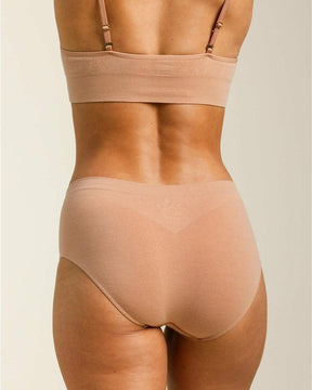 Woman wearing BRANWYN's Essential Hipster, a underwear from the Essential Collection. Made from soft, moisture-wicking Merino wool using seamless technology, this performance innerwear provides performance, comfort, and sustainability. The fabric is free from BPA, PFAS, and forever chemicals.