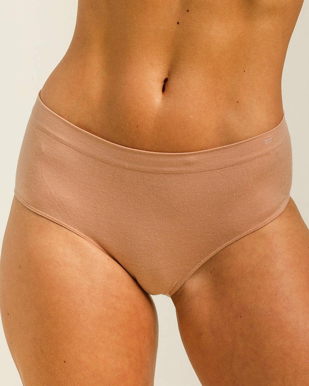 Woman wearing BRANWYN's Essential Hipster, a underwear from the Essential Collection. Made from soft, moisture-wicking Merino wool using seamless technology, this performance innerwear provides performance, comfort, and sustainability. The fabric is free from BPA, PFAS, and forever chemicals.