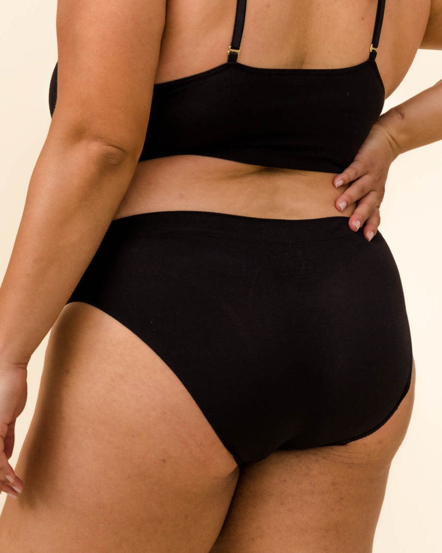 Woman wearing BRANWYN's Essential Hipster, a underwear from the Essential Collection. Made from soft, moisture-wicking Merino wool using seamless technology, this performance innerwear provides performance, comfort, and sustainability. The fabric is free from BPA, PFAS, and forever chemicals.